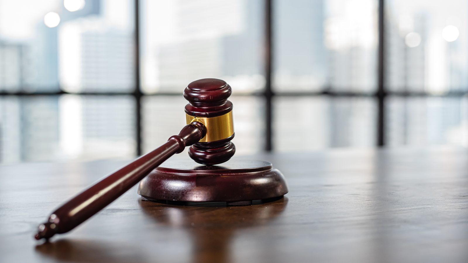 Wooden judge's gavel on a desk in a law office, representing the legal steps an Oregon family faces in the first 30 days after a wrongful death